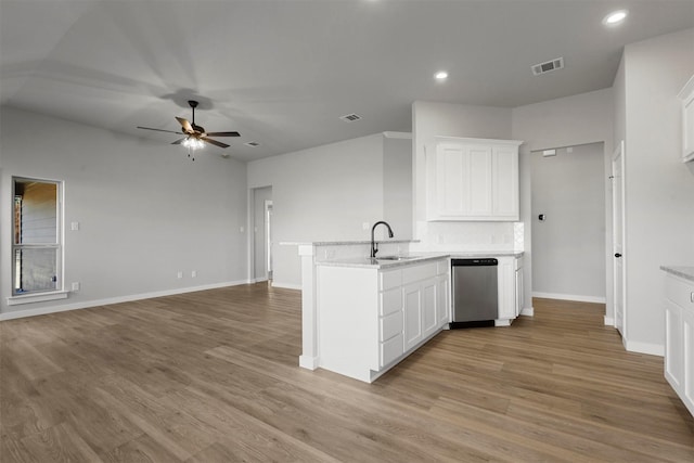 kitchen with kitchen peninsula, stainless steel dishwasher, ceiling fan, sink, and white cabinetry