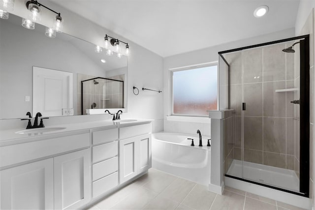 bathroom featuring tile patterned floors, vanity, lofted ceiling, and plus walk in shower