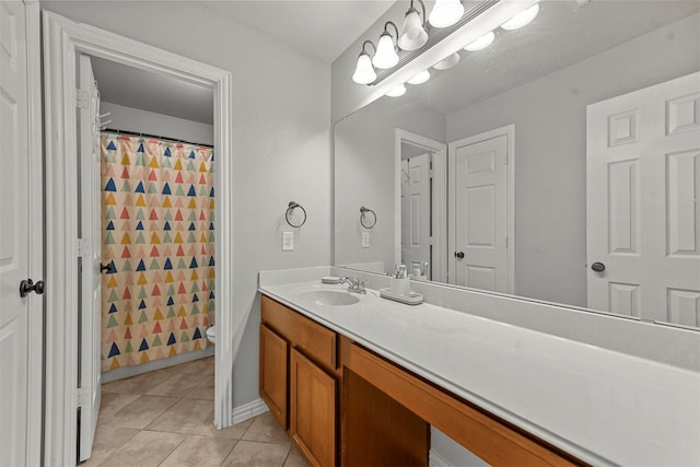 bathroom with vanity, a shower with curtain, tile patterned floors, and toilet