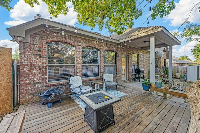 deck with a fire pit and grilling area