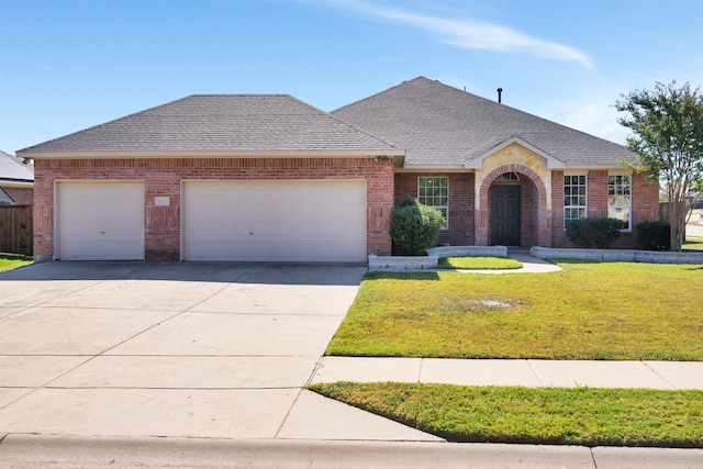 ranch-style home featuring a garage and a front lawn