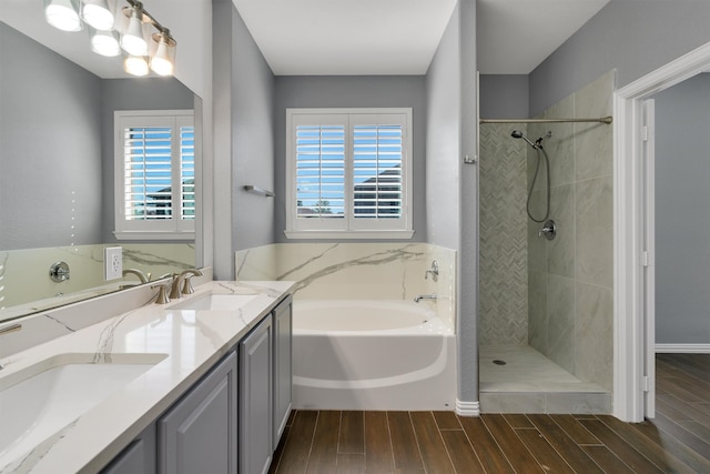 bathroom featuring vanity, a healthy amount of sunlight, wood-type flooring, and independent shower and bath