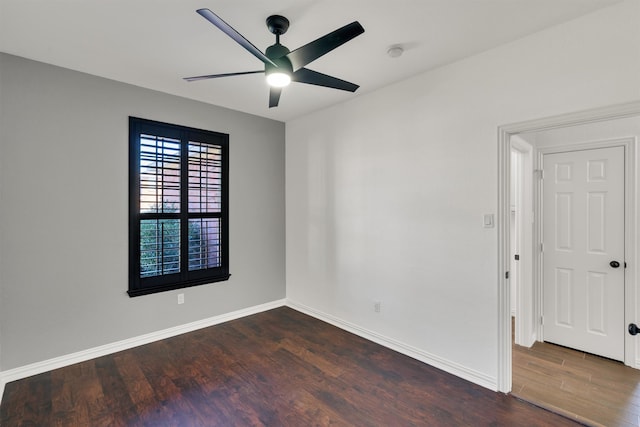 spare room with ceiling fan and dark hardwood / wood-style floors