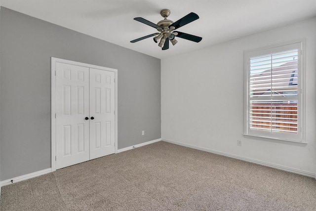 unfurnished bedroom featuring carpet flooring, a closet, and ceiling fan