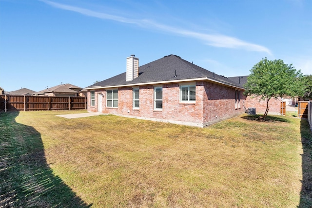 rear view of property with a patio and a lawn