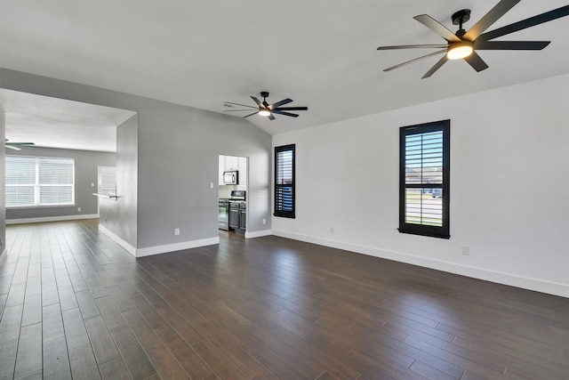 unfurnished living room with ceiling fan, vaulted ceiling, and dark hardwood / wood-style floors