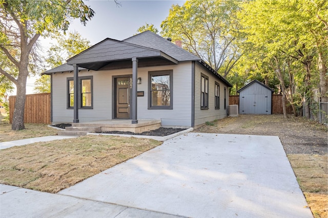 bungalow featuring a storage unit and a porch