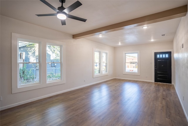 interior space featuring ceiling fan, beamed ceiling, and dark wood-type flooring