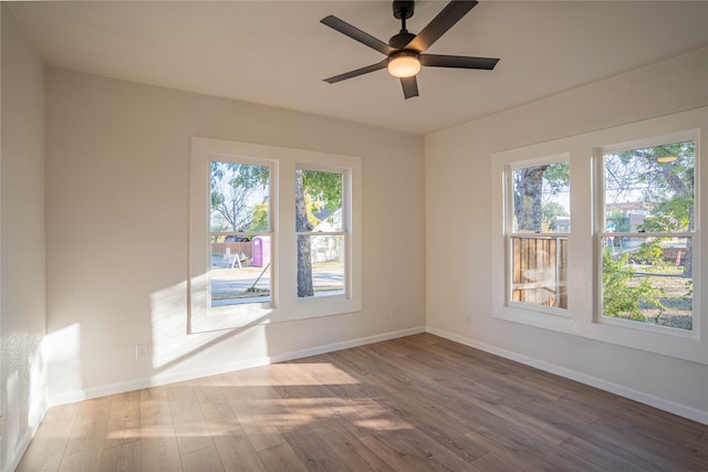 spare room featuring hardwood / wood-style floors and ceiling fan