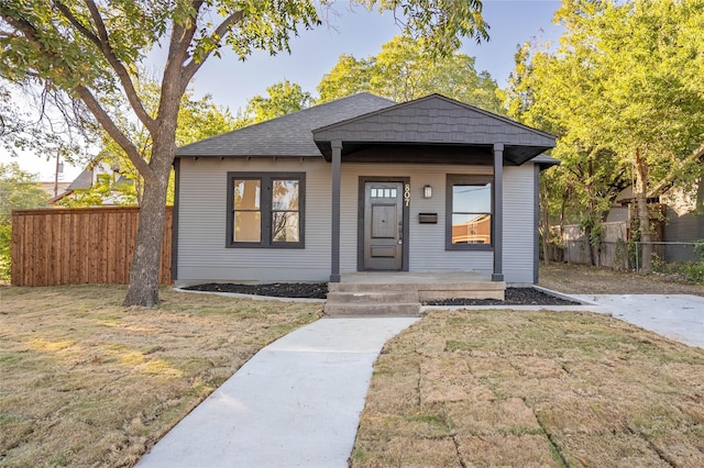 bungalow-style home featuring a front yard and a porch