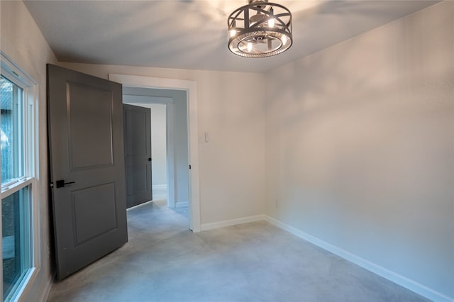 spare room with a notable chandelier