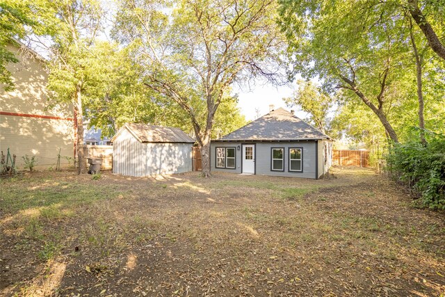 back of property featuring a storage shed