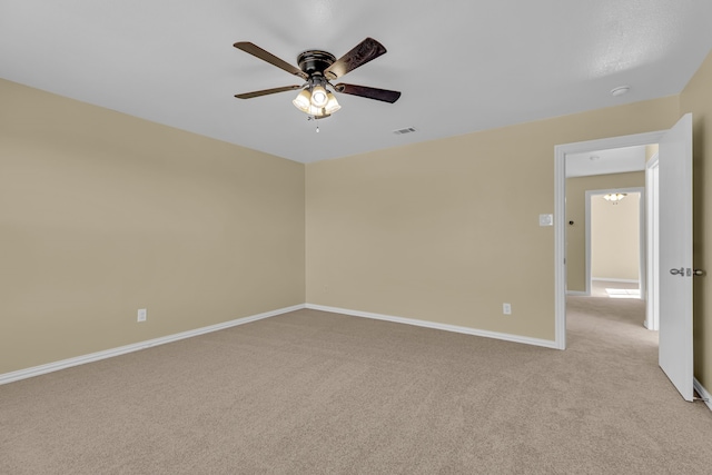 carpeted empty room featuring ceiling fan