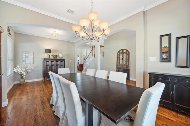dining space with visible vents, a chandelier, baseboards, arched walkways, and dark wood finished floors