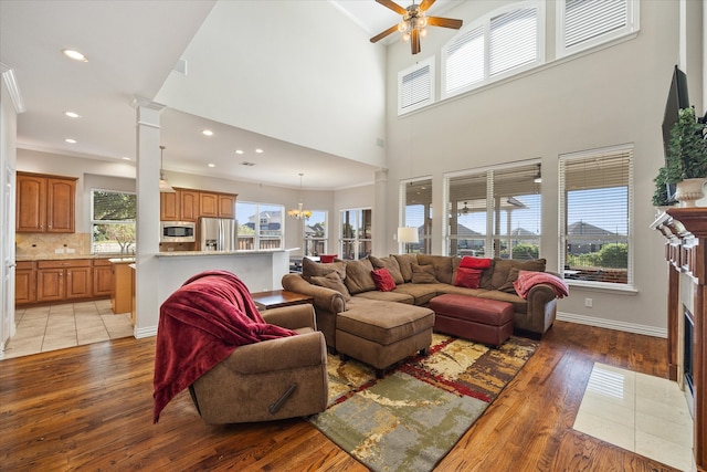 living room with a wealth of natural light, a tile fireplace, and light hardwood / wood-style floors