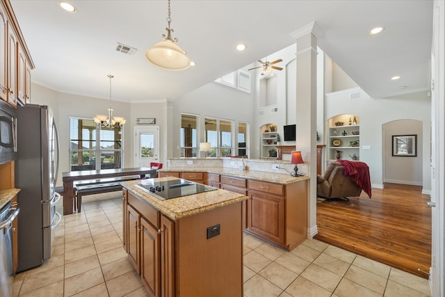 kitchen featuring light tile patterned flooring, stainless steel appliances, decorative light fixtures, and a kitchen island