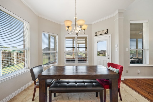 dining room featuring light tile patterned floors, crown molding, plenty of natural light, and a chandelier