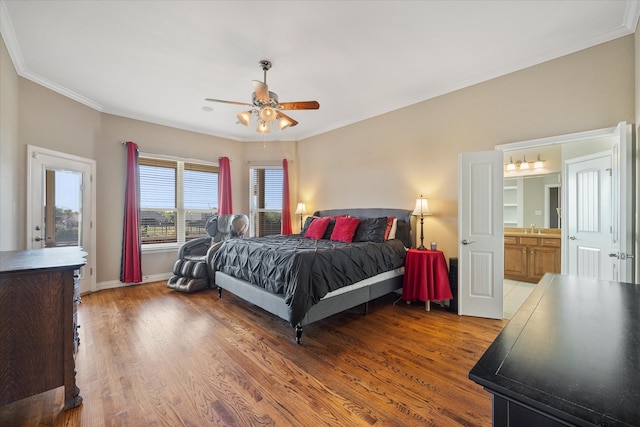 bedroom with connected bathroom, hardwood / wood-style floors, sink, ceiling fan, and crown molding