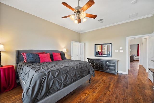 bedroom featuring crown molding, dark hardwood / wood-style floors, and ceiling fan