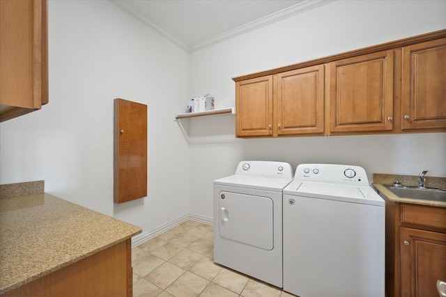 laundry area with light tile patterned flooring, separate washer and dryer, sink, cabinets, and ornamental molding