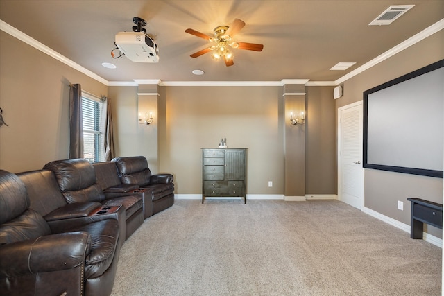 carpeted cinema with crown molding and ceiling fan