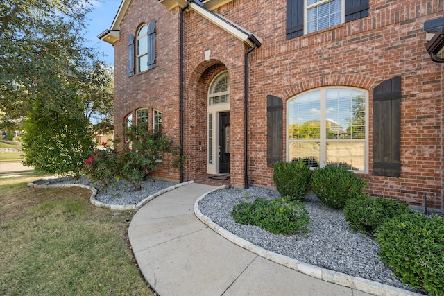 doorway to property with a lawn