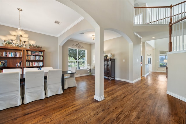 unfurnished dining area with crown molding, a notable chandelier, and dark hardwood / wood-style flooring