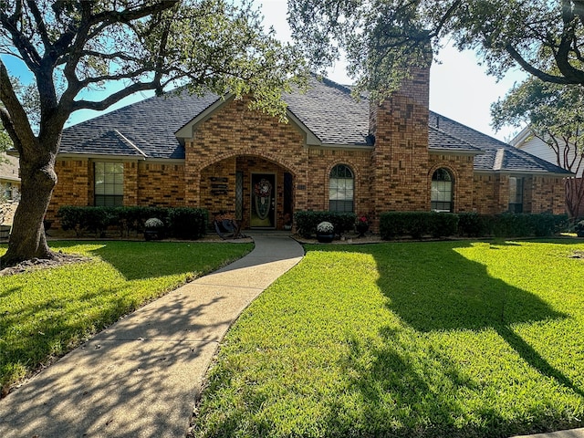 tudor house featuring a front lawn