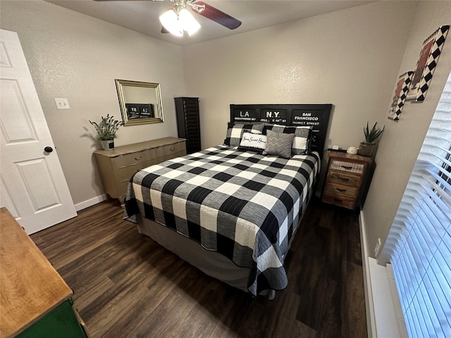 bedroom with dark hardwood / wood-style flooring and ceiling fan