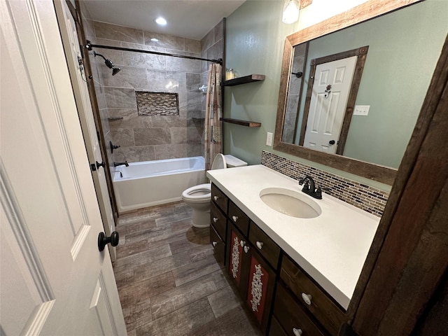 full bathroom with backsplash, hardwood / wood-style floors, shower / bath combination with curtain, toilet, and vanity