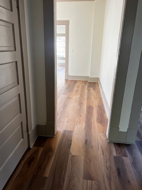 hallway with hardwood / wood-style floors