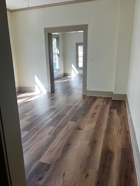 unfurnished room with ornamental molding and dark hardwood / wood-style flooring