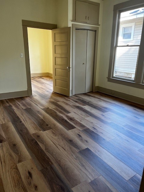 unfurnished bedroom featuring a closet and hardwood / wood-style flooring