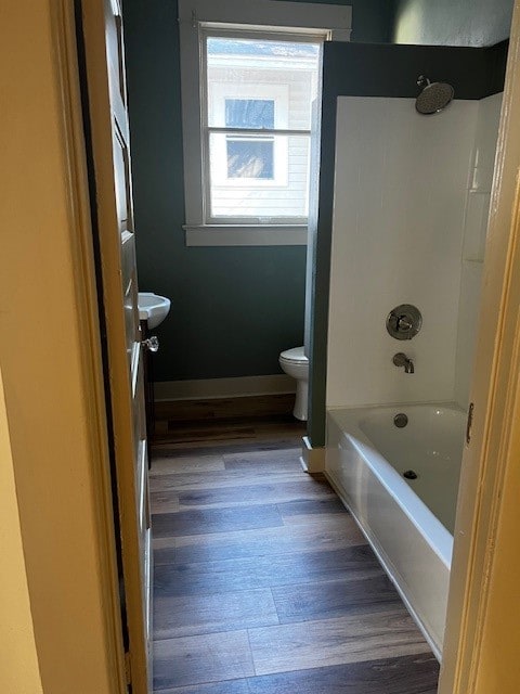 bathroom with toilet, bathtub / shower combination, and wood-type flooring