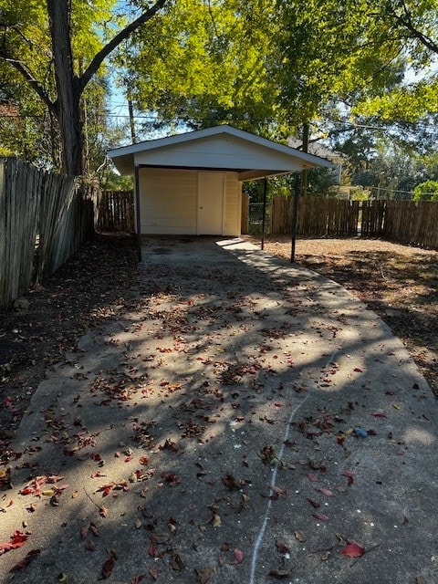 exterior space featuring a storage unit and a carport