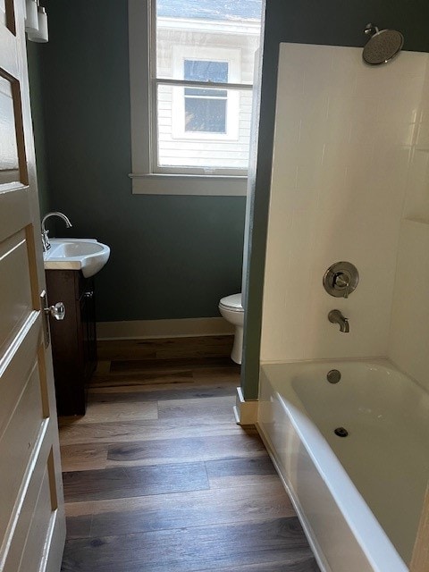 full bathroom featuring vanity, hardwood / wood-style floors, toilet, and tub / shower combination