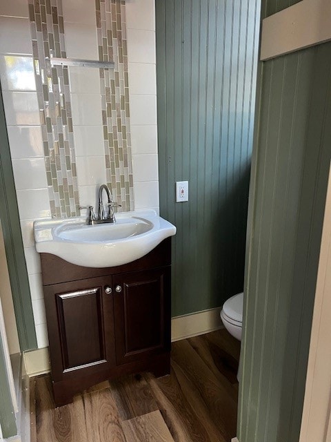 bathroom with vanity, toilet, and wood-type flooring