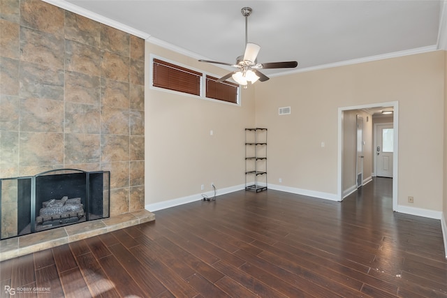 unfurnished living room with ornamental molding, dark wood-type flooring, a fireplace, and ceiling fan