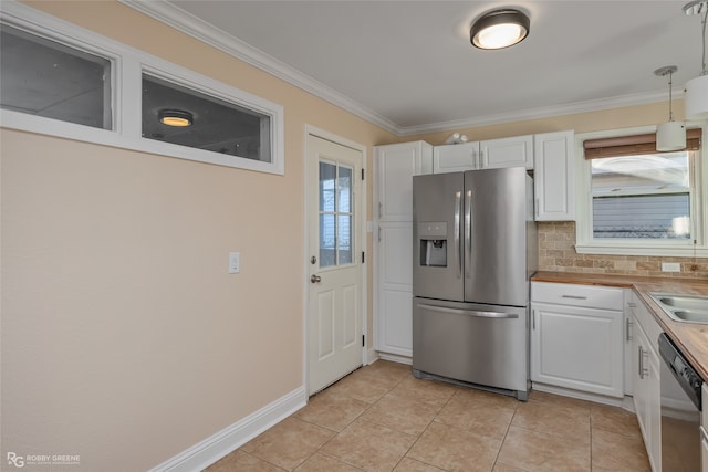 kitchen featuring white cabinetry, crown molding, appliances with stainless steel finishes, and decorative backsplash