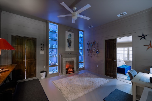 living room with wooden walls and ceiling fan