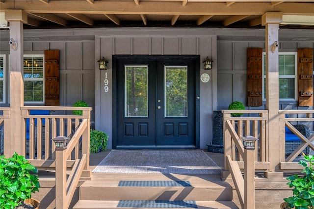 view of exterior entry with a porch