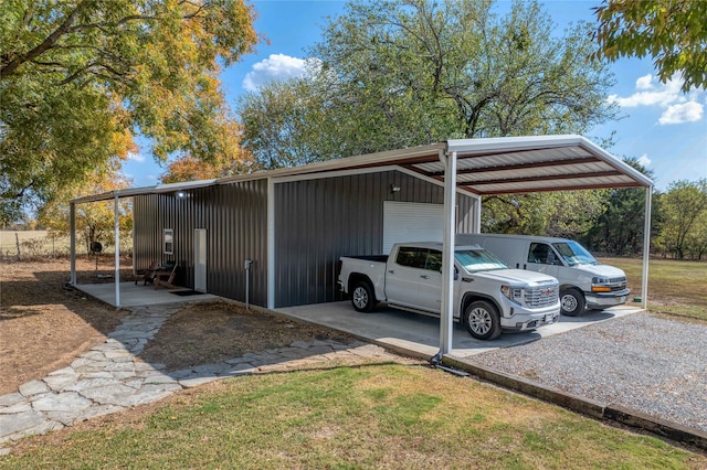 view of parking with a garage, a lawn, and a carport