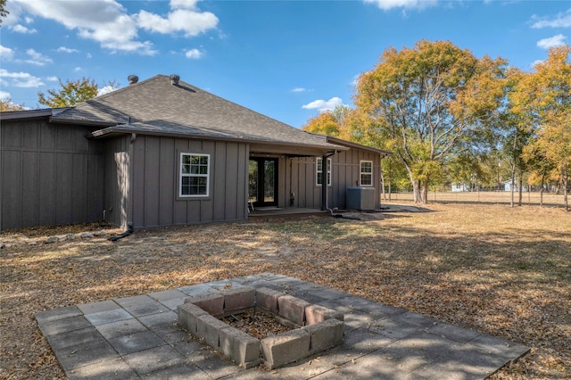 back of property with an outdoor fire pit and a patio area