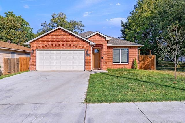 view of front of house featuring a front yard and a garage