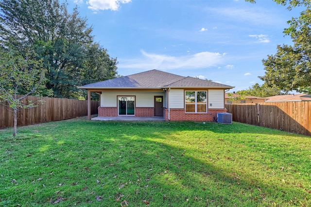 back of house with a patio, a yard, and central air condition unit