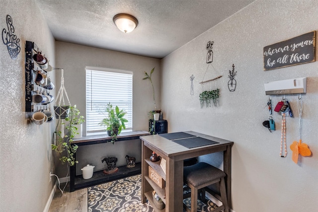 office space featuring a textured ceiling and hardwood / wood-style flooring