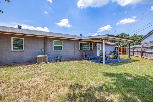 back of house featuring a patio area, a yard, and cooling unit