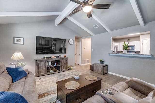 living room with vaulted ceiling with beams, light hardwood / wood-style floors, and ceiling fan