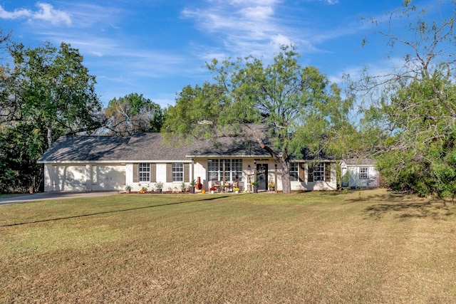 single story home featuring a front yard and a garage