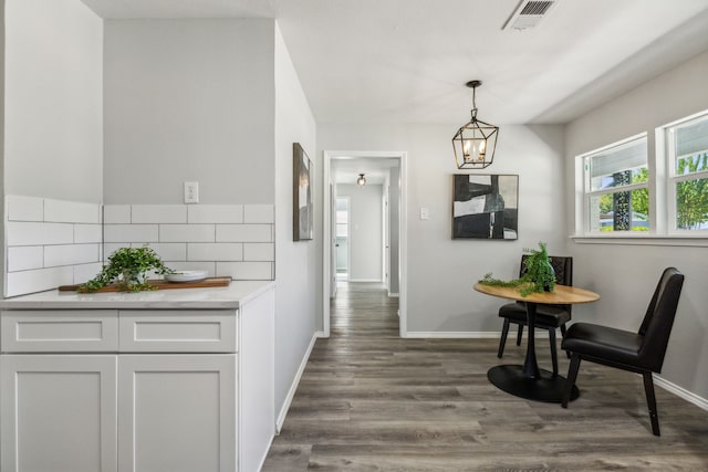 dining room featuring dark hardwood / wood-style floors and a chandelier